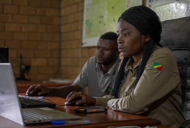 Odzala-Kokoua Law Enforcement | Woman working on laptop while man looks on